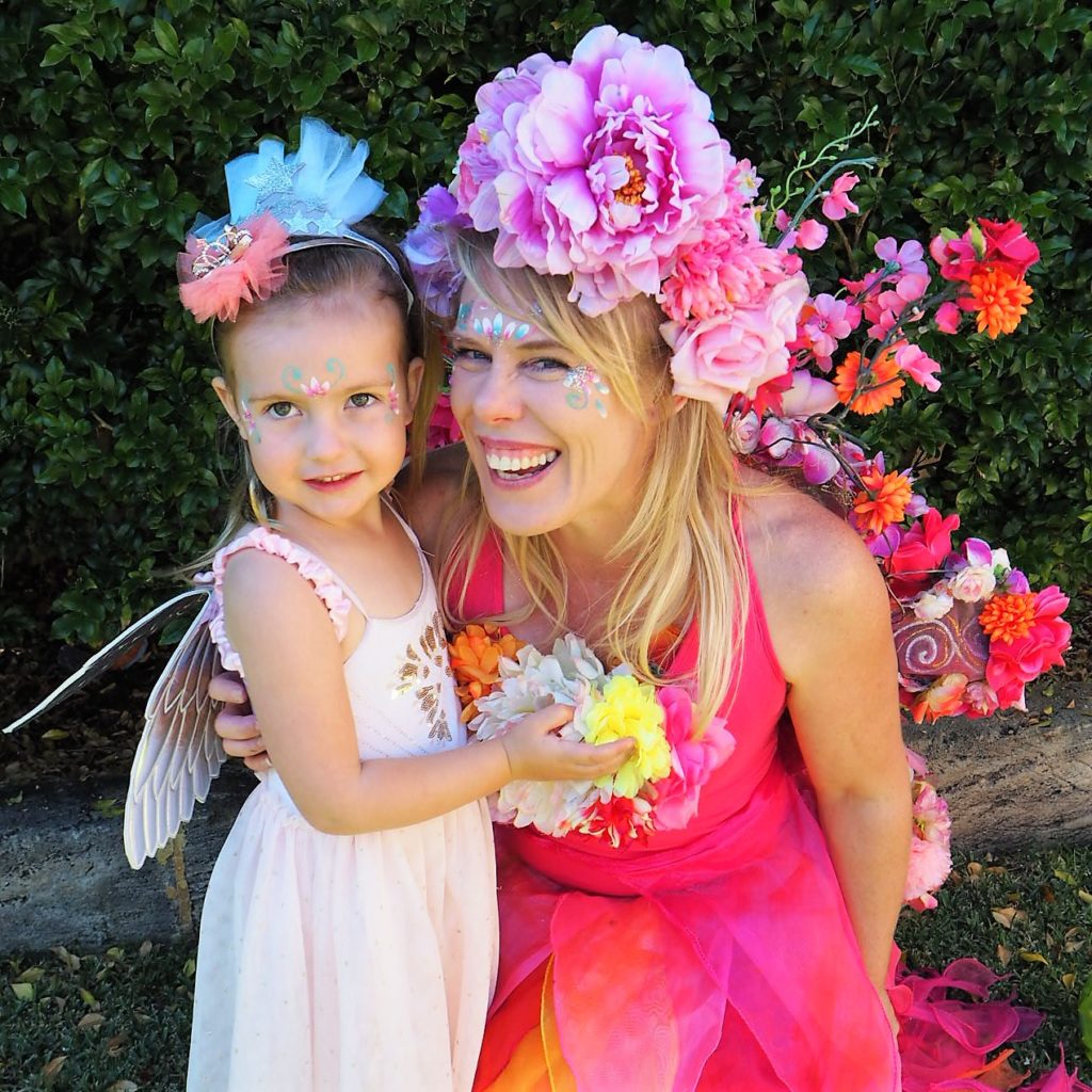 OLYMPUS DIGITAL CAMERA A woman dressed as a fairy with a little girl.