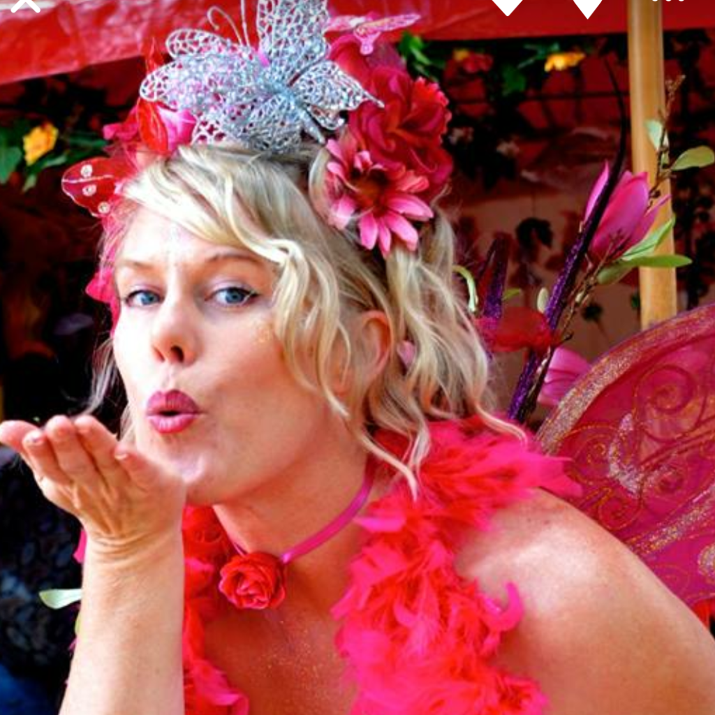 Square wishes A woman dressed as a fairy blowing a kiss.