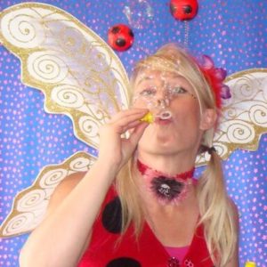 old disco bubbles A woman dressed as a ladybug blowing bubbles.