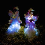 Two people dressed in fairy clothing.