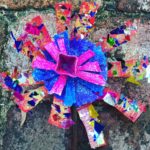 Flower Craft A flower made out of paper on a brick wall.