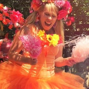 LWW square dancing A woman dressed in an orange tutu with flowers in her hair.