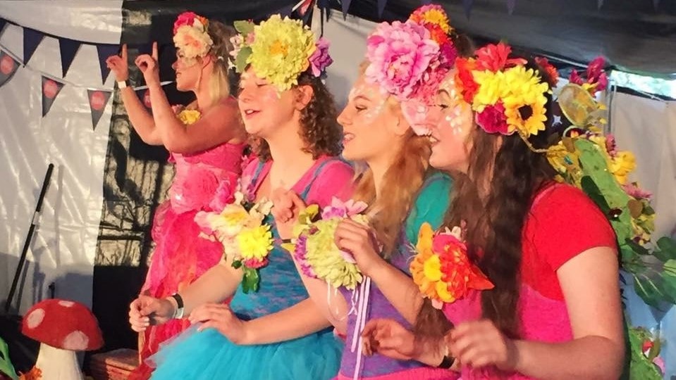 A group of girls dressed up in flower crowns.